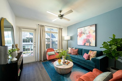 a living room with blue walls and a blue couch